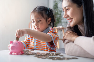 Young Learner Collecting Coins with Encouraging Parent