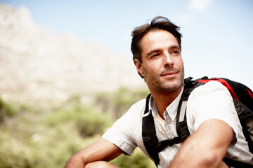 Rest, hiking and man on mountain top with thinking, peace and fitness on holiday adventure for travel. Break, inspiration and calm hiker on hill with backpack, relax and outdoor vacation in nature.