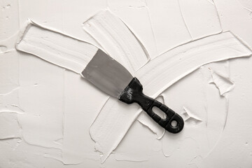 Knife on white putty, top view