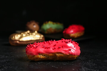 Sweet eclairs on dark background