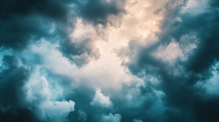 Obraz premium A dramatic sky filled with dark cloud and a hint of light breaking through.