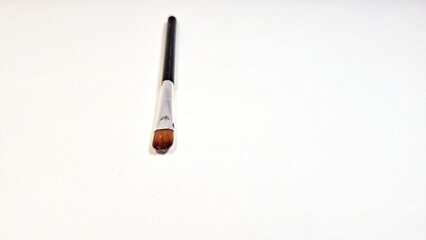 Fototapeta premium Isolated of used eyebrow pencil black color with white color background. used for drawing eyebrows on women. Brush for eyebrow.