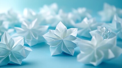 Top-down view of origami snowflakes scattered on a soft, pastel blue background, illuminated by natural light to show off the precision of each fold and the delicate craftsmanship. --ar 16:9