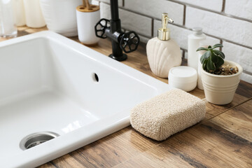 Bath supplies on wooden table in bathroom