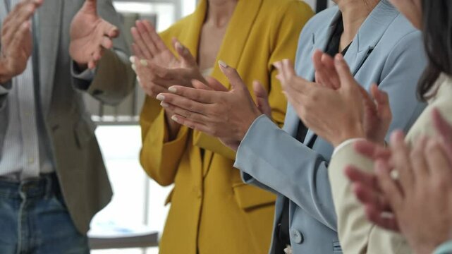 Group of successful young business professionals standing side by side Folding arms, smiling, holding hands, clapping, expressing congratulations. Achieve business success together within the office.