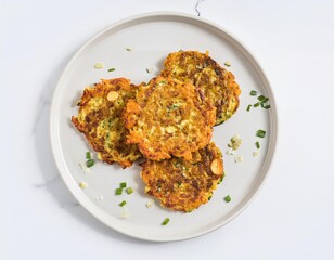Fototapeta premium Delicious sweet potato and zucchini rosti with chives on a plate