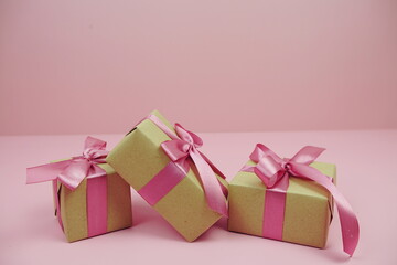 Gift boxes presents wrap with paper craft and pink ribbon on pink background