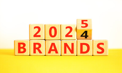 Planning 2025 brands new year symbol. Concept words 2024 Brands to 2025 Brands on beautiful wooden blocks. Beautiful yellow table white background. Business 2025 brands new year concept. Copy space.