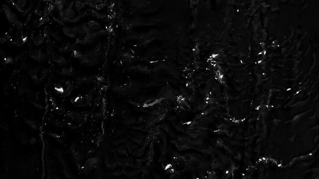 Alien slime sliding on the wall, on a black background, special effect for science fiction movie.