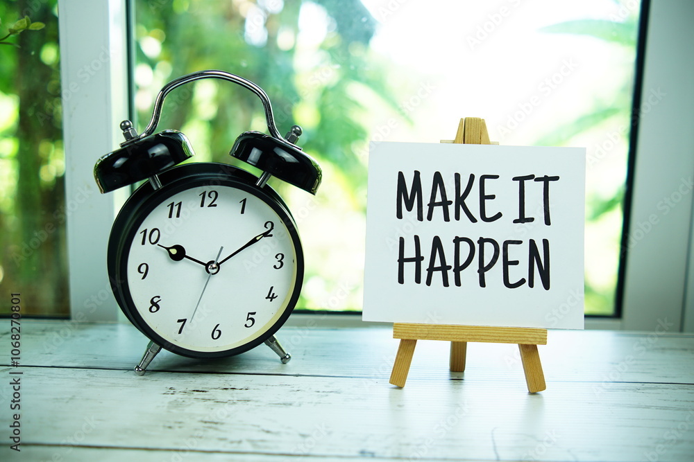 Poster make it happen quotes text on paper card with easel and alarm clock in the window background