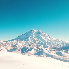 A snow-capped mountain under a clear blue sky, showcasing natural beauty.