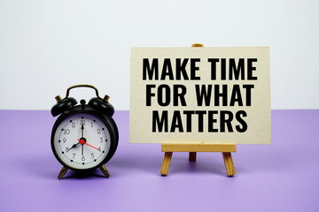 Make the for what matters text on paper card with alarm clock on purple background
