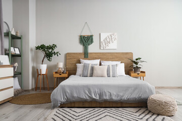 Modern interior of stylish bedroom with houseplants