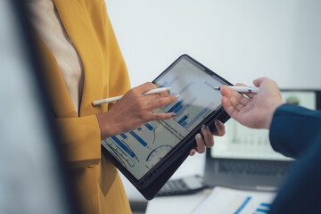 Analyzing the Data:  Two business professionals discuss data analysis, highlighting the importance...