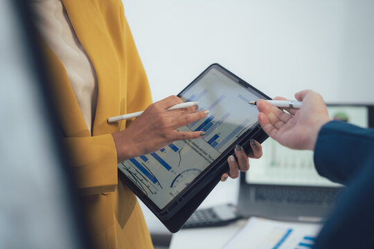 Analyzing the Data:  Two business professionals discuss data analysis, highlighting the importance of data-driven decisions in the modern workplace.