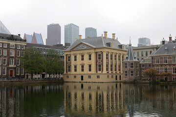 Fototapeta premium The Mauritshuis museum building and Binnenhof - Dutch Parliament with Hofvijver pond, The Hague, The Netherlands;
