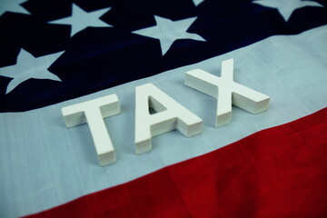 TAX alphabet letters with USA flag background