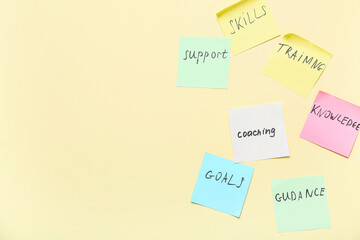 Sticky notes with words on beige background. Coaching concept