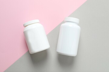 White bottles on color background 