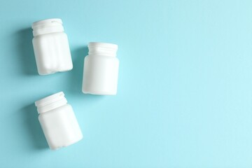 White bottles on color background 
