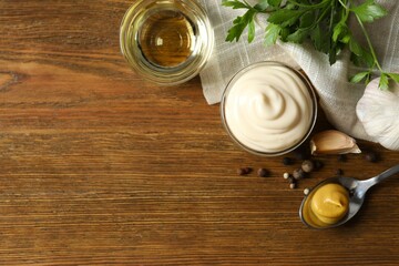 Bowl with mayonnaise and ingredients for cooking on wooden background