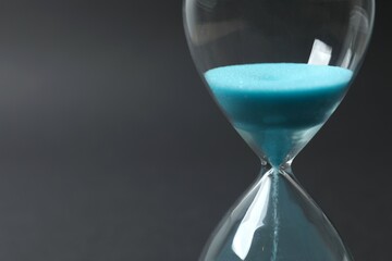 Modern hourglass on black background. Hourglass time concept for business deadline, urgency and outcome of time