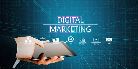 Close up of male hands using tablet with glowing digital marketing hologram on dark blue background. product ads and promotion concept.