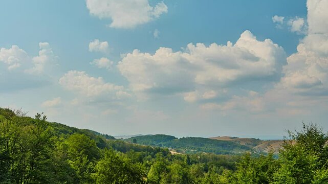 Nature landscape cumulus clouds rolling over hills and mountains time-lapse