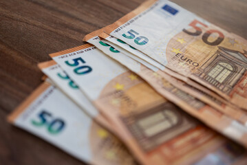 Euro banknotes placed on table demonstrate concept of economic integration and trade within Eurozone by eliminating exchange rate risks and transaction costs