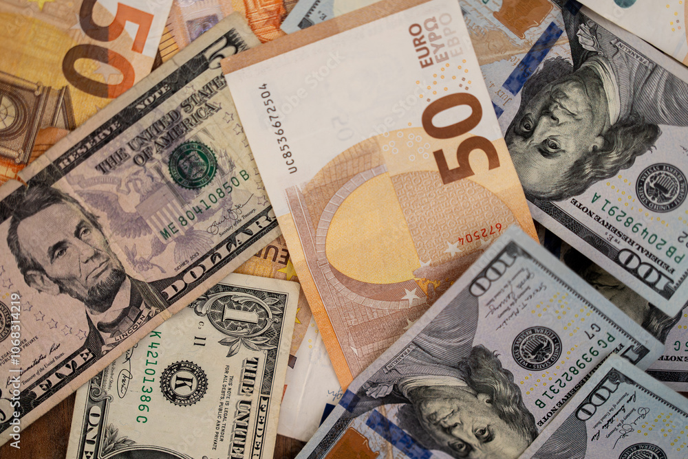 Poster Dollar bills with euro banknotes placed on table demonstrate concept of tight correlation in exchange rate of dominant currencies in global monetary system