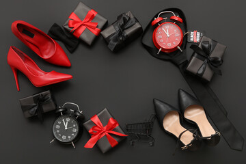 Fototapeta premium Frame made of gifts, male accessories, female shoes and alarm clocks on dark background. Black Friday sale