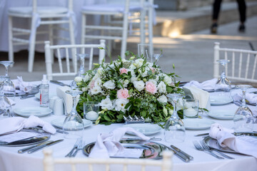Outdoor Wedding Reception Setup with Elegant Tables and Floral Centerpieces