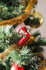 Christmas tree decorations. A red boot on a Christmas tree. New Year holiday. Xmas