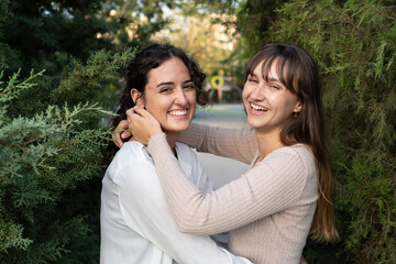 Two girls in a loving couple sharing a tender moment at the park
