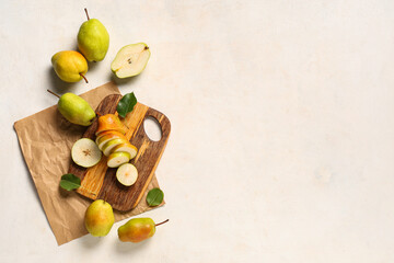 Wooden board with slices of sweet ripe pears on white background