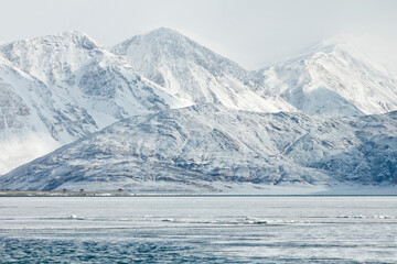 Pangong Lake or Pangong Tso and snow mountain range in Leh Ladakh, India.