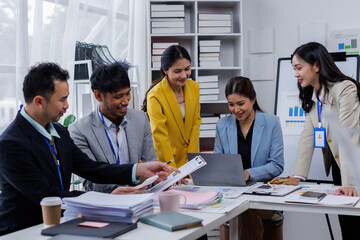 Group of confident business asian people point to graphs and charts to analyze market data, balance sheet, account, net profit to plan new sales strategies to increase production capacity.	