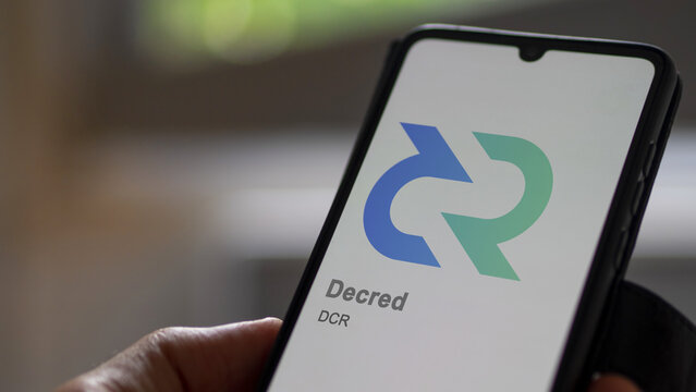Close up on logo of (DCR) Decred on the screen of an exchange. (DCR) Decred price stocks, $DCR on a device.