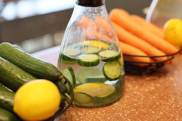 A vibrant and colorful mix of infused water featuring fresh cucumbers, zesty lemons, and crunchy...