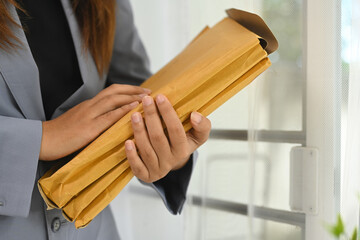Cropped shot office worker managing document folders in office