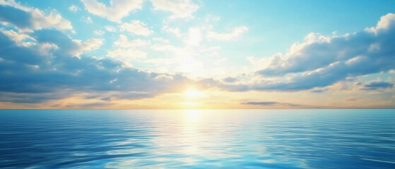 Obraz premium Peaceful ocean sunrise with soft clouds and golden sunlight reflecting on calm water, capturing a serene coastal morning.