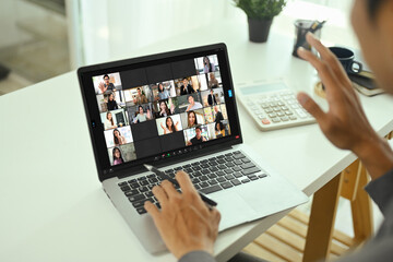 Businessman participating in online team meeting via video chat