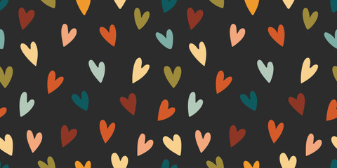 Seamless pattern of hearts in boho style. Simple hand drawn pastel color heart repeating on dark background for textile. Vector illustration