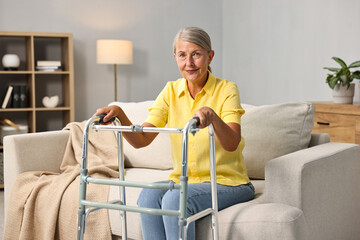 Senior woman with walking frame on sofa at home
