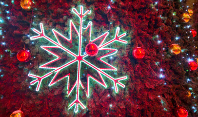 Big glowing snowflake close-up on Christmas tree