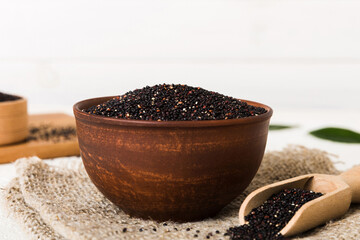 quinoa seeds in bowl and spoon on colored background. Healthy kinwa in small bowl. Healthy superfood