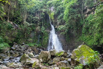 A waterfall amidst a lush green forest, Mount Kilimanjaro, Tanzania