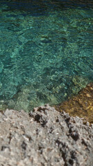 Clear water flowing over rocks in a serene outdoor setting in mallorca, spain, with vibrant colors reflecting off the surface.