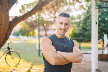 Portrait of a smiling man athlete in the open air