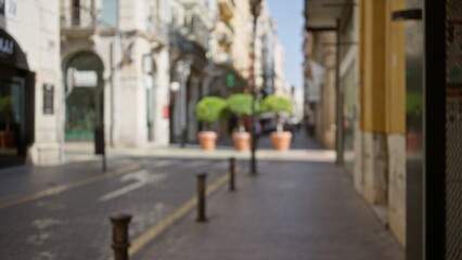 Defocused view of a vibrant outdoor urban street with blurred background, showing pedestrians...
